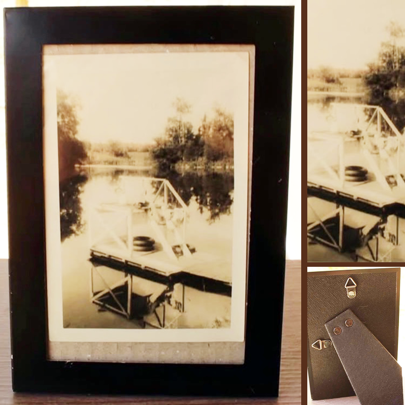 A vintage photo of a structure on a lake with a person lying on it, capturing a quiet, carefree moment suspended in time