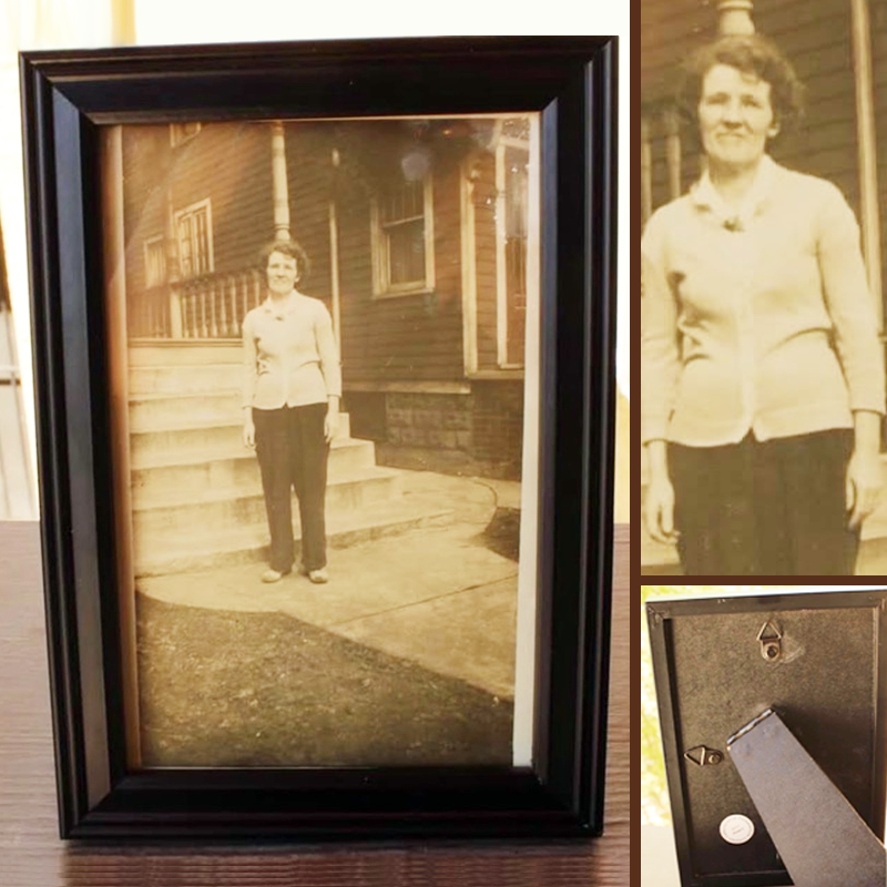 A vintage framed photo of an older lady by the porchside steps